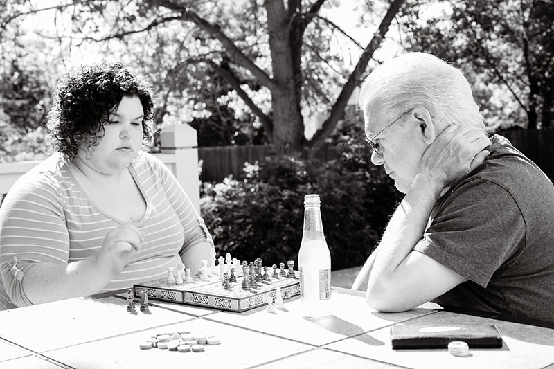 dad and daughter playing chess