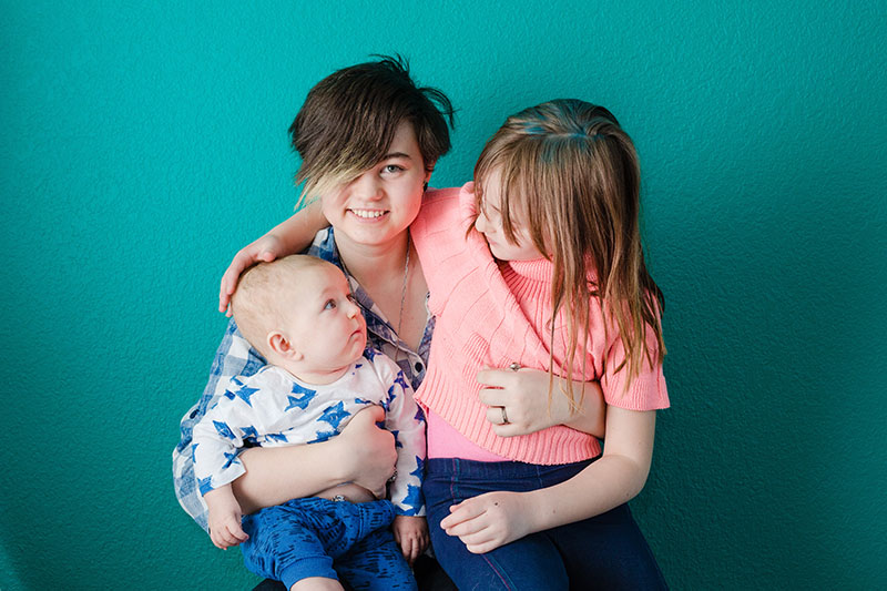 brother and two sisters family portrait