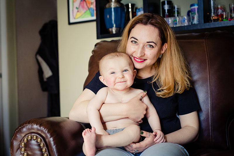 mom holding smiling baby