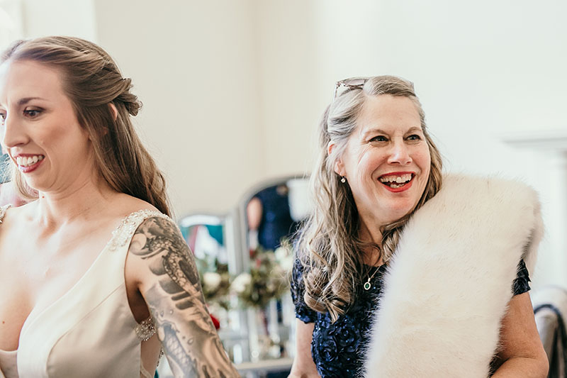 mom laughing while getting ready at wedding