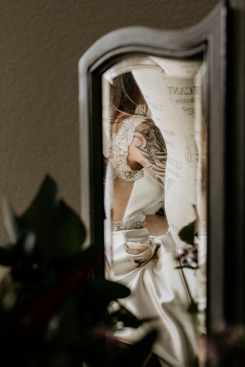 bride's tattoo reflection in mirror while getting ready