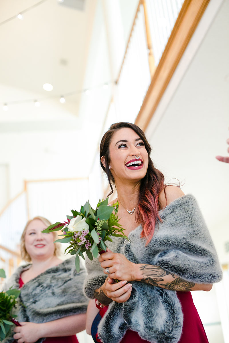 bridesmaid laughing at wedding with flowers