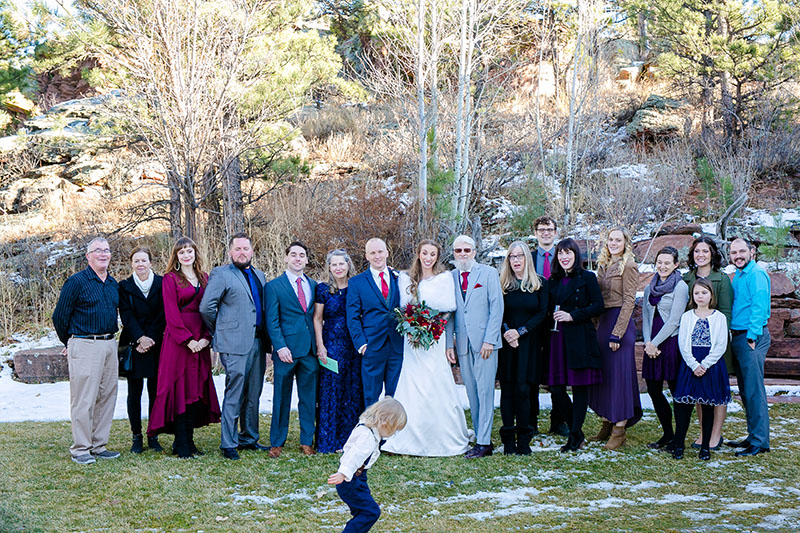 little kid photo bombing a wedding group portrait