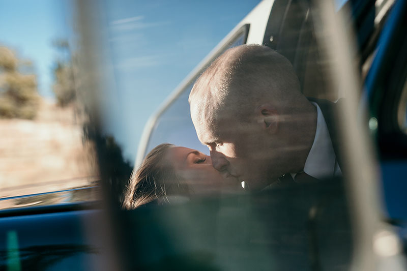 bride and groom reflection in truck mirror