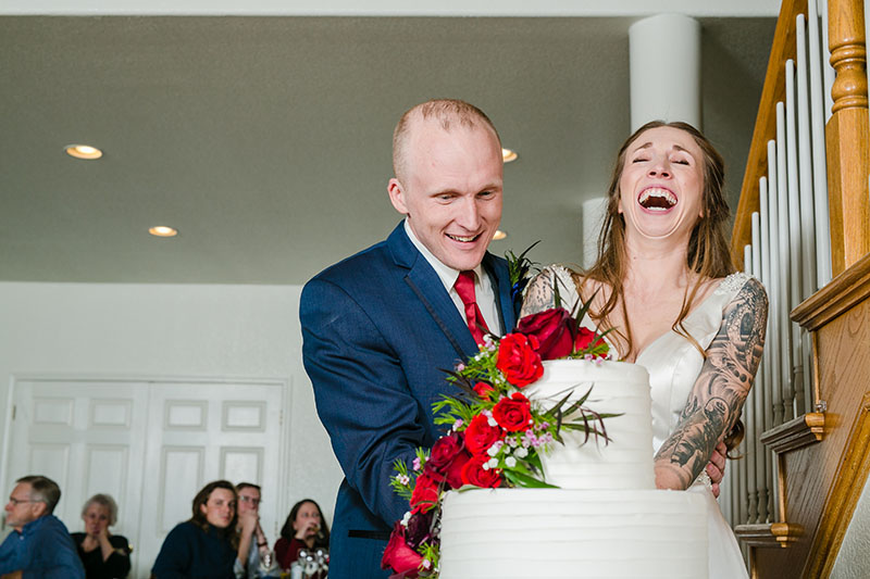 bride and groom cutting cake at wedding